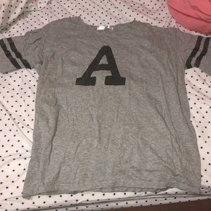 gray t-shirt with a “A”